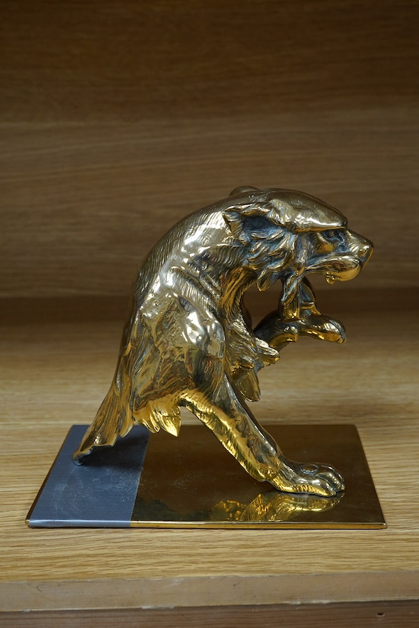 A substantial brass car mascot of the front half of a big cat roaring, mounted on a sheet of brass, 15cm high. Condition - good.